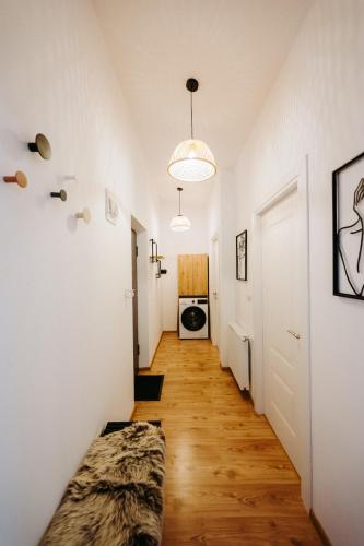 a hallway with white walls and wooden floors at Modern Loft One in Suceava