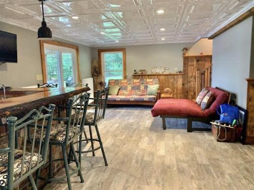 a living room with a bar and a couch at OWL HOUSE LIMIT 8 home in Wakefield
