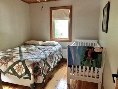 a bedroom with a bed and a window at OWL HOUSE LIMIT 8 home in Wakefield