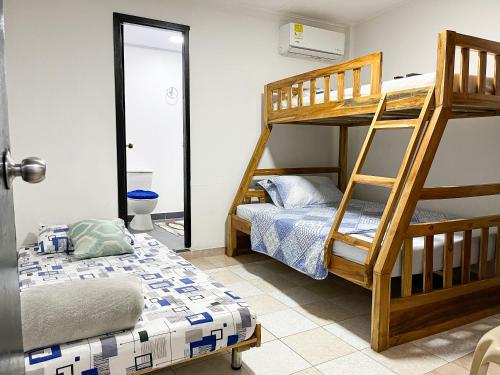 a bedroom with two bunk beds and a bed at Miss Yasmin Place in San Andrés