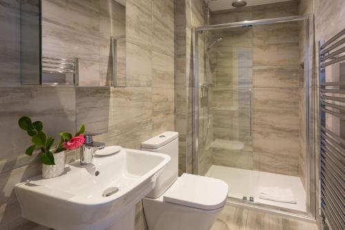a bathroom with a toilet and a sink and a shower at Scots Craig in St Ives