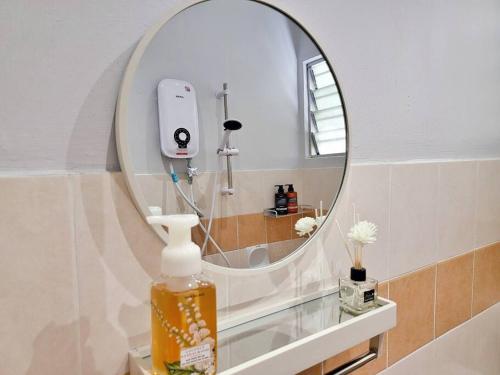 a bathroom with a mirror and a soap dispenser at Sunway Cozy Apartment near Lost World of Tambun in Ipoh