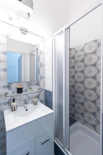 a bathroom with a sink and a shower at Urban Oasis Apartment in Budapest