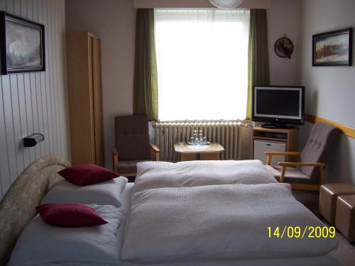 a hotel room with two beds and a window at pension Jesen in Benecko