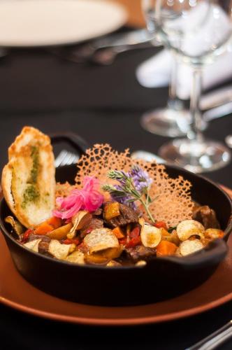 a bowl of food with bread and vegetables on a table at Colores de Purmamarca in Purmamarca