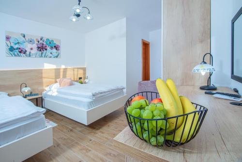 a basket of fruit on a table in a room at Apartment & rooms Vila Toplissa in Varaždinske Toplice