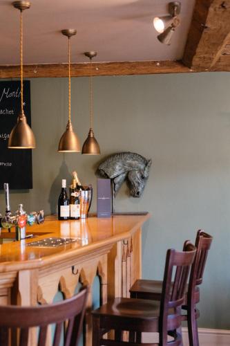 a bar with a cat statue on the wall at The Crown, Bildeston in Bildeston