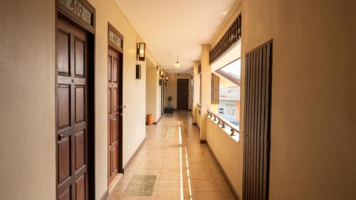an empty hallway with a door and a window at Trithana Boutique House in Chiang Mai