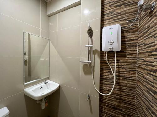 a bathroom with a shower and a sink at Pekan Auto City Budget Hotel in Pekan