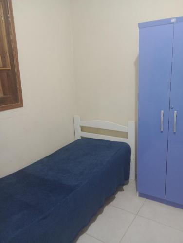 a bedroom with a blue bed and a blue cabinet at Mar doce lar in Cabo de Santo Agostinho