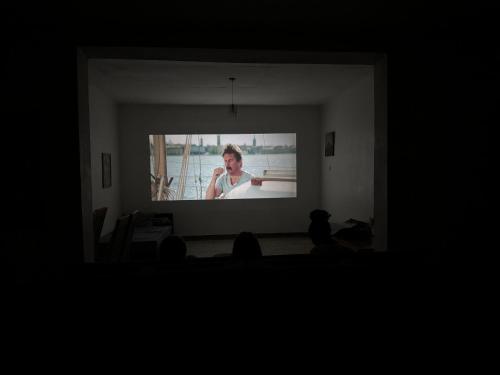 a woman on a projection screen in a living room at Karibu Africa Home in Moshi
