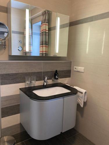 a bathroom with a sink and a mirror at Ferienwohnungen LARA Wohnung 1 in Wallgau