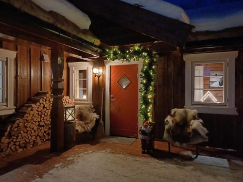 a room with a red door and two dogs sitting in front at Malangen Lodge in Mestervik