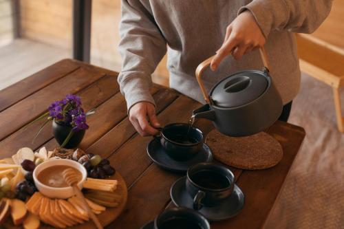 a person pouring coffee into cups on a table at ARMBEE Honey Farm in Alaverdi