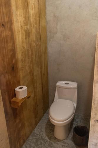 a bathroom with a toilet and two rolls of toilet paper at M a r e a V i v a - O a x a c a in Zipolite