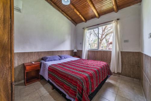 a bedroom with a bed and a window in it at el bosque la foret in Gualeguaychú