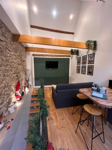 a living room with a couch and a table at Le nid d’Isa in Hautvillers