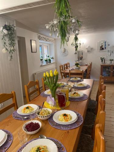 a dining room table with plates of food on it at Ranczo Frodyma in Stronie Śląskie