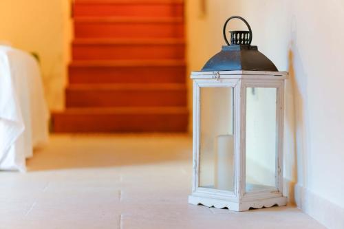 a lantern in a hallway with stairs in the background at GH Flat Studio S.Martino in Carloforte