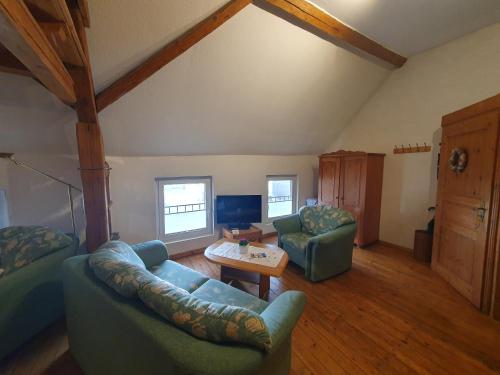 a living room with a couch and a table at Bauernstube Scheidterhof in Kobern-Gondorf