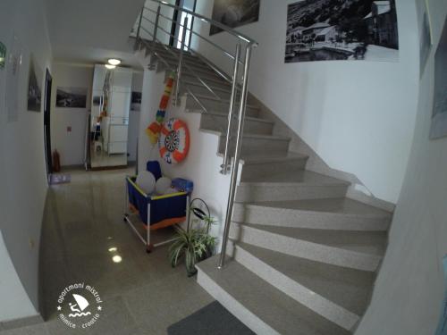 a staircase in a building with a stair case at Apartments Mistral in Mimice