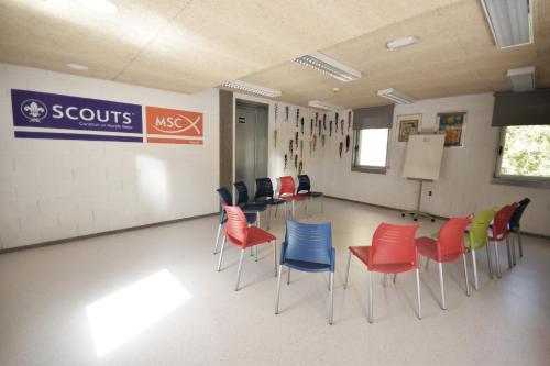 a classroom with chairs and a board in a room at Scout Madrid Hostel in Madrid