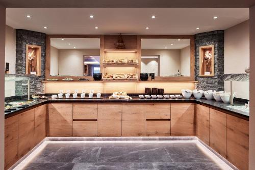a large kitchen with wooden cabinets and a counter top at Panorama Samnaun in Samnaun