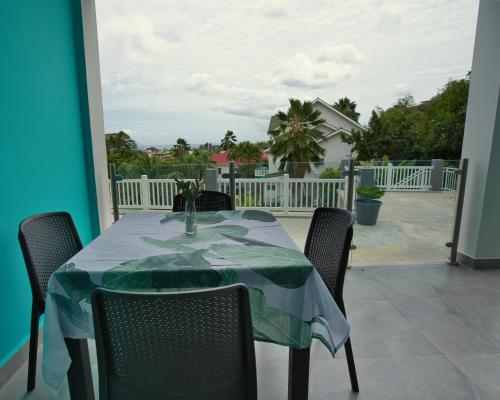 a table with a green table cloth on a patio at Sunset Haven Villa in Beau Vallon
