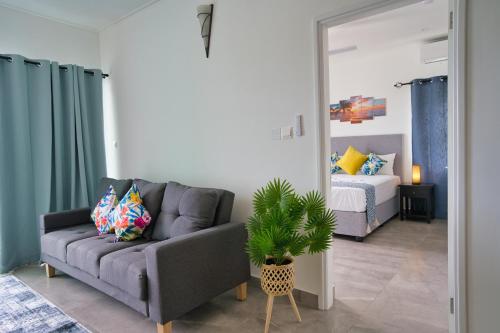 a living room with a couch and a bedroom at Sunset Haven Villa in Beau Vallon