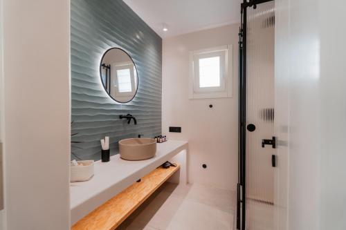 a bathroom with a sink and a mirror at Oliving Mykonos Luxury Suites in Klouvas
