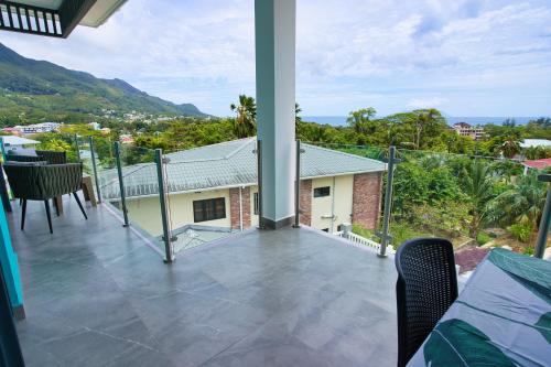 a balcony with a view of a house at Sunset Haven Villa in Beau Vallon