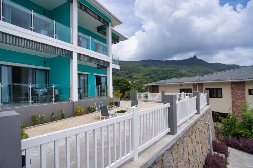 a house with a white fence in front of it at Sunset Haven Villa in Beau Vallon