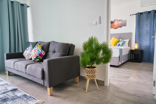 a living room with a couch and a potted plant at Sunset Haven Villa in Beau Vallon