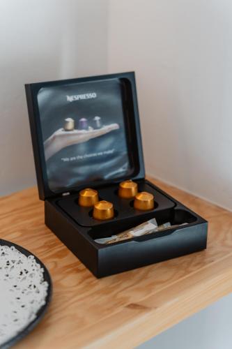 a black box with cupcakes in it on a table at Oliving Mykonos Luxury Suites in Klouvas
