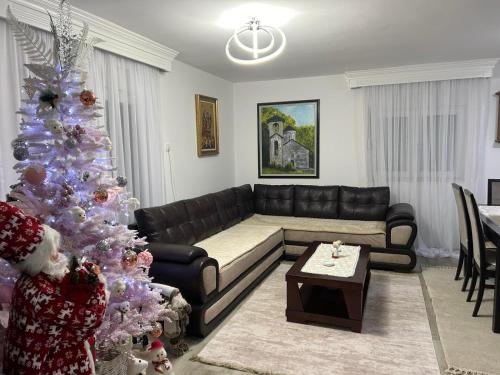 a living room with a christmas tree and a couch at Jezerina in Šavnik