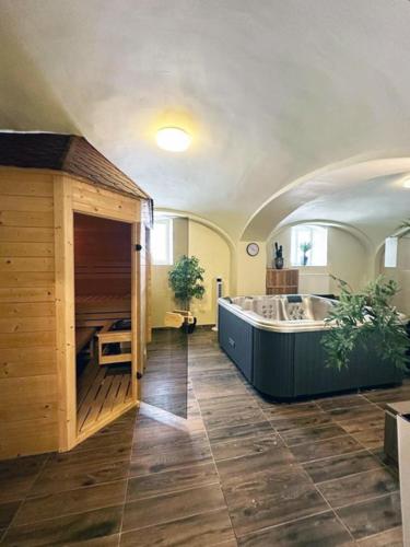 a large bathroom with a large tub in a room at Wienerwald Residenz in Baden