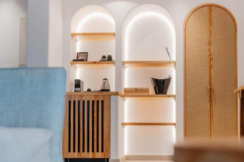 a room with wooden shelves and two surfboards at Oliving Mykonos Luxury Suites in Klouvas