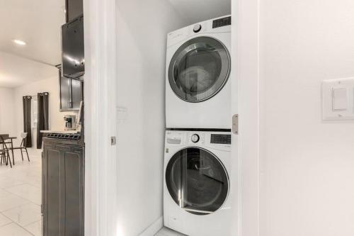 two washing machines in a kitchen next to a wall at Your Downtown Home With California King Bed Unit A in Phoenix