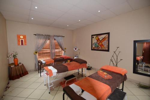 a room with four beds and a window at Attaché Guest Lodge & Health Spa in Midrand