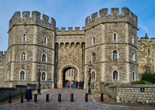 a castle with people standing in front of it at Queen Annes court luxury apartment on high street in Windsor