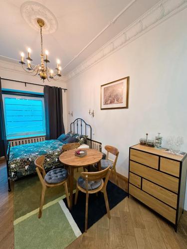 a bedroom with a table and a bed and a desk at Cozy 33m2 2-room Studio Apartment in City Center in Rīga