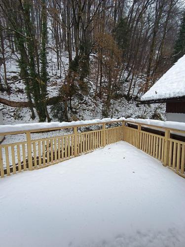 a wooden fence covered in snow next to a house at Cozy Stay Apartments in Salzburg