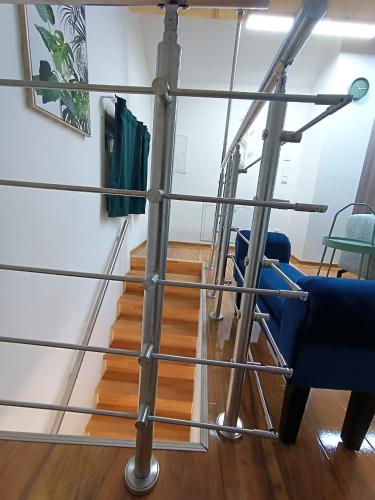 a metal pole with a blue chair and stairs at Cozy Stay Apartments in Salzburg