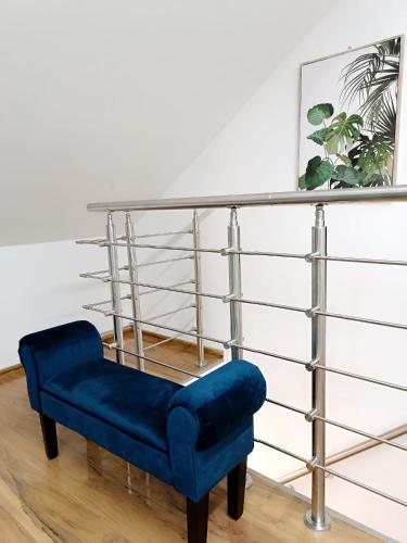 a blue chair sitting in front of a shelf at Cozy Stay Apartments in Salzburg
