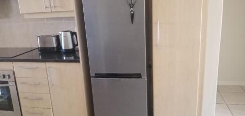 a stainless steel refrigerator in a kitchen at Bougain Villas in Cape Town