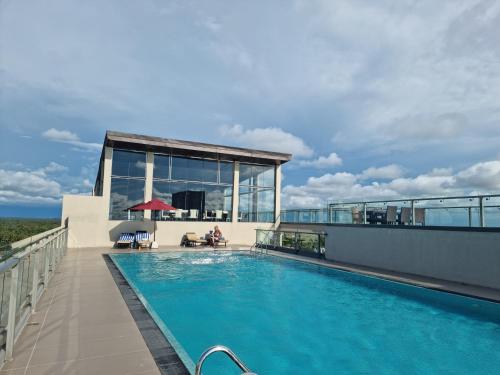 a swimming pool on the roof of a building at Ocean Breeze Residence- Negombo in Negombo