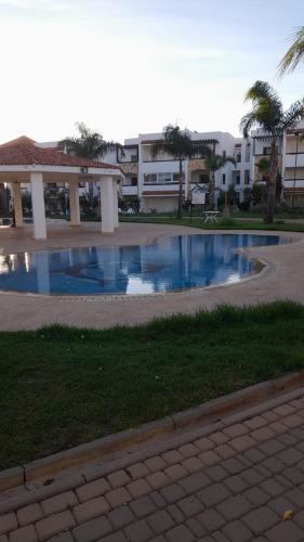 a large swimming pool in front of a building at Marina Golf appartement de luxe in Asilah