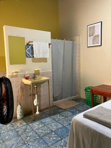 a bathroom with a shower and a sink in a room at Hostal El Amate #1 in Suchitoto