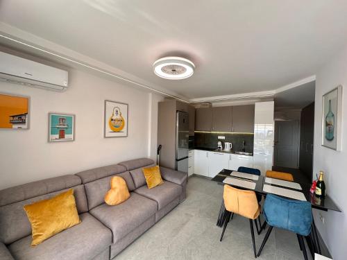 a living room with a couch and a table at Sunset Apartment & Heated Pool in Los Cristianos