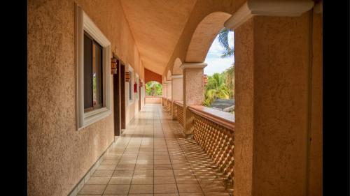 an empty hallway of a building with a window at Los Barriles Hotel in Los Barriles